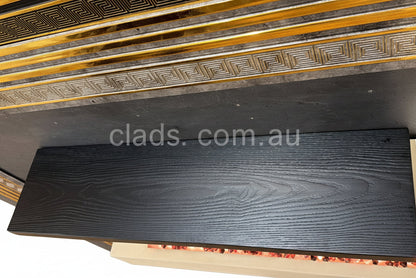 Black wooden floating shelves by Cladding Supplies of Australia, showcasing sleek wall-mounted storage with a modern finish.