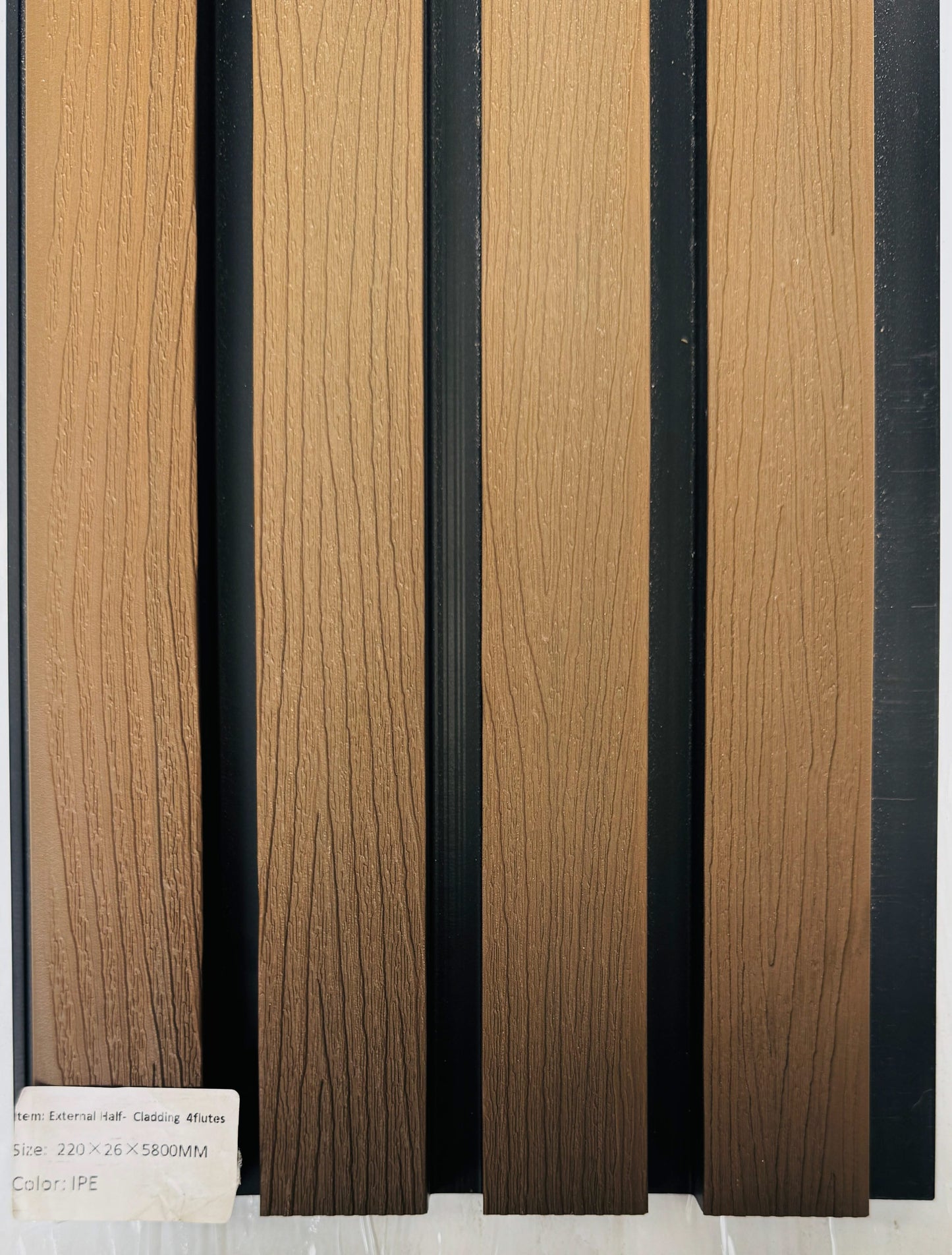 External Ipe tree pattern half cladding with four slats, 5.8 meters long, installed on a building exterior, showcasing natural wood finish.
