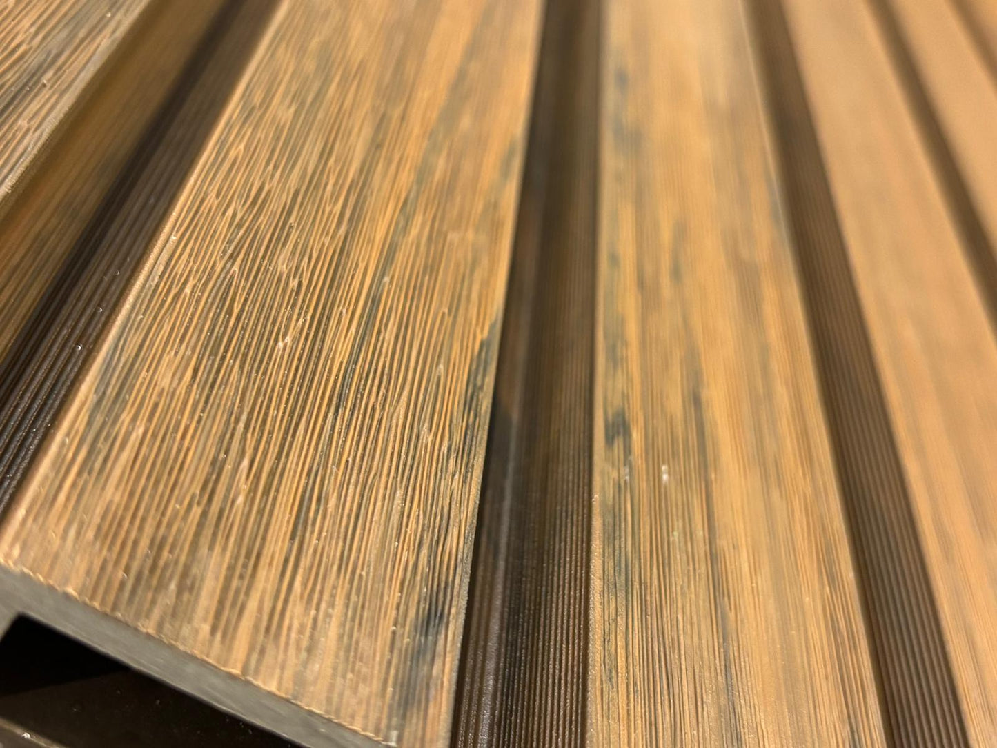 Exterior walnut cladding with four slats by Clads Australia, showcasing natural wood grain and sleek design for outdoor applications.